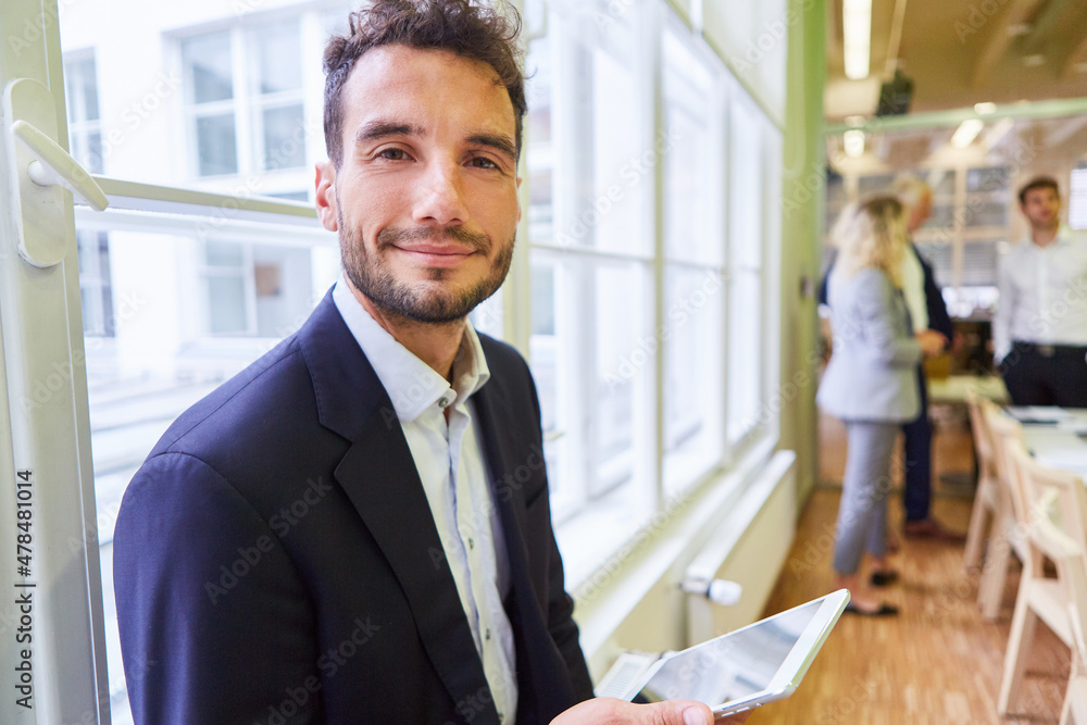 Young businessman using tablet computer Young businessman using tablet computer