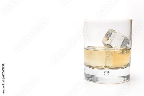 filled whiskey glass ice cubes white background