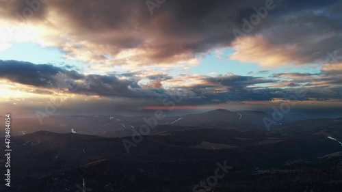 Cinematic movement - hyperlapse. Beatifull and smooth fly above forest and moutains during sunset in winter.	