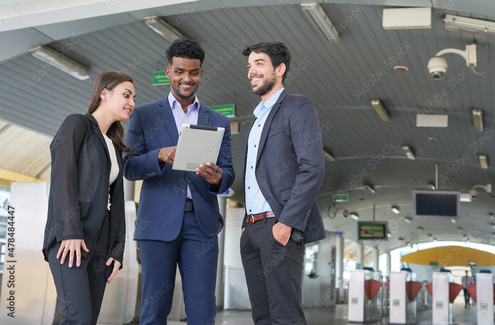 business inspectors using tablet and talking about business together in front of skytrain fare gates business inspectors using tablet and talking about business together in front of skytrain fare gates