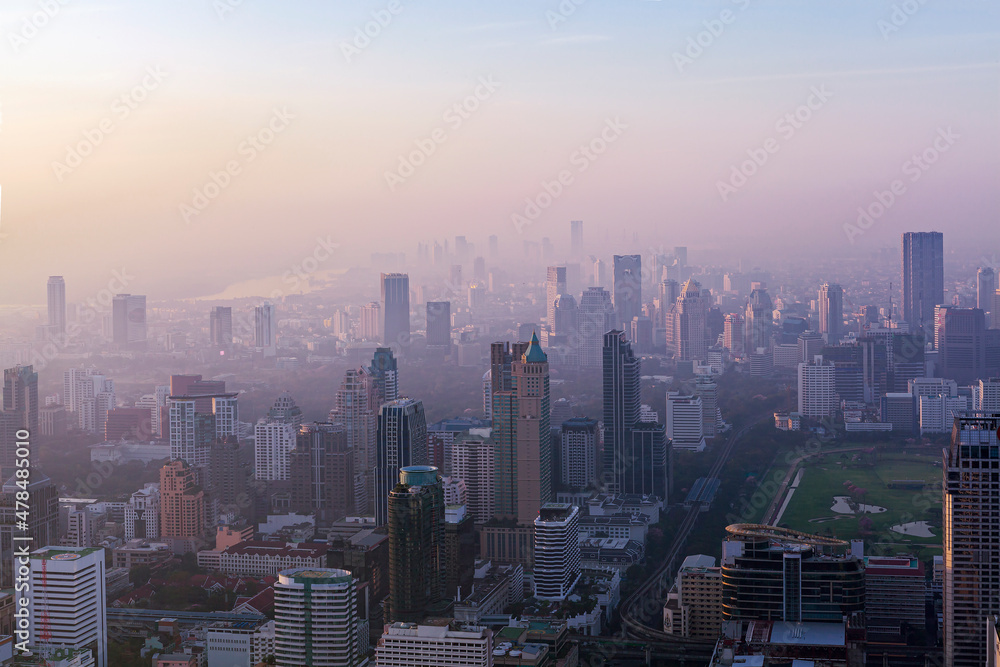Dawn over Bangkok. At the height of a bird's flight. Smog hell city.
