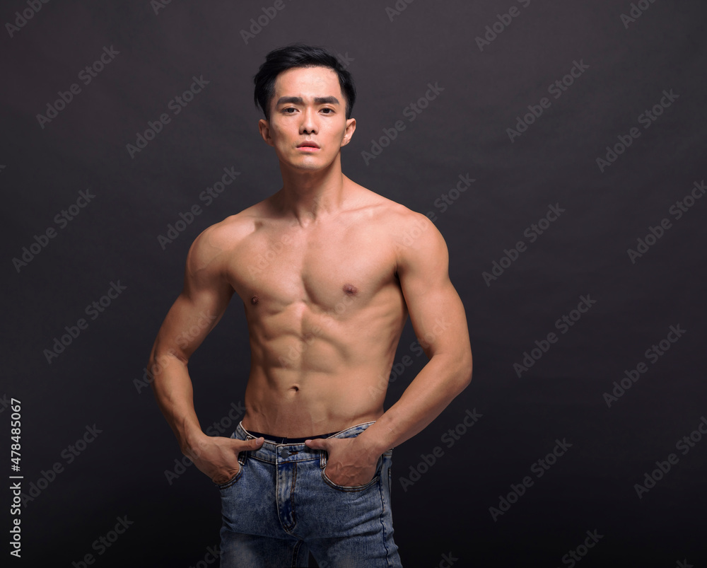 Fototapeta premium Muscular bodybuilder guy doing posing over black background