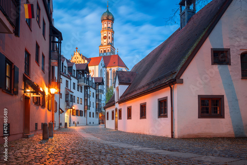 Obraz na płótnie Augsburg, Germany. Cityscape image of old town street of Augsburg, Germany with the Basilica of St. Ulrich and Afra at autumn sunset. w salonie