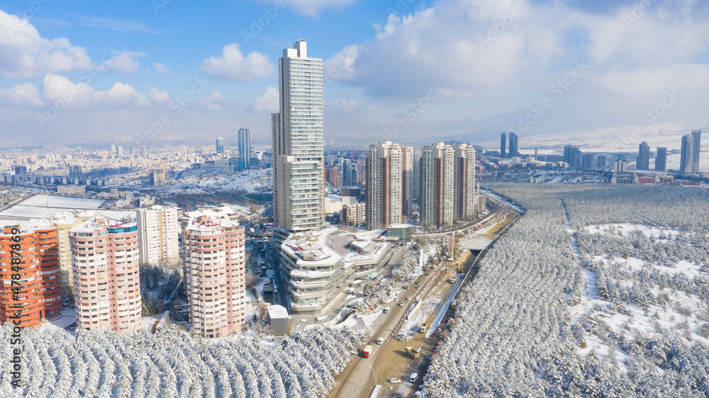 Naklejka premium Aerial view of snowy forest and skyscrapers in Capital Of Turkey,ANKARA.