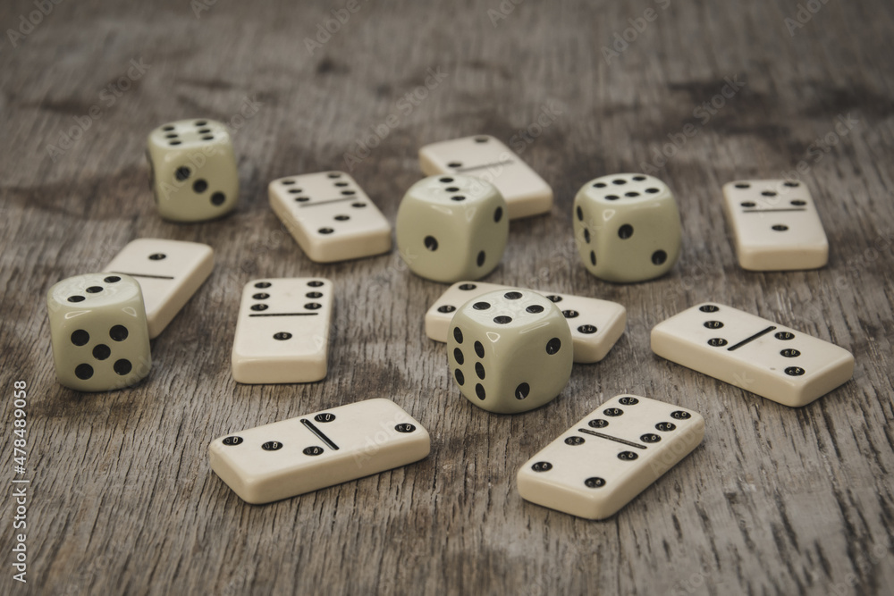 Dice and dominoes on wooden table, casino luck Dice and dominoes on wooden table, casino luck