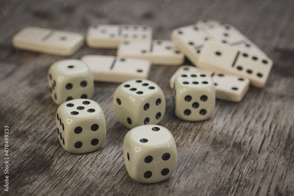 Dice and dominoes on wooden table, casino luck Dice and dominoes on wooden table, casino luck