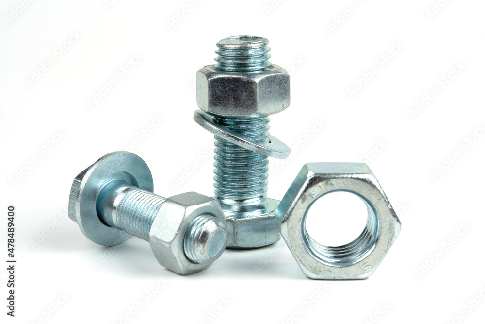 Several large silver metal bolts. Bolts, nuts and washers on a white background close up Several large silver metal bolts. Bolts, nuts and washers on a white background close up