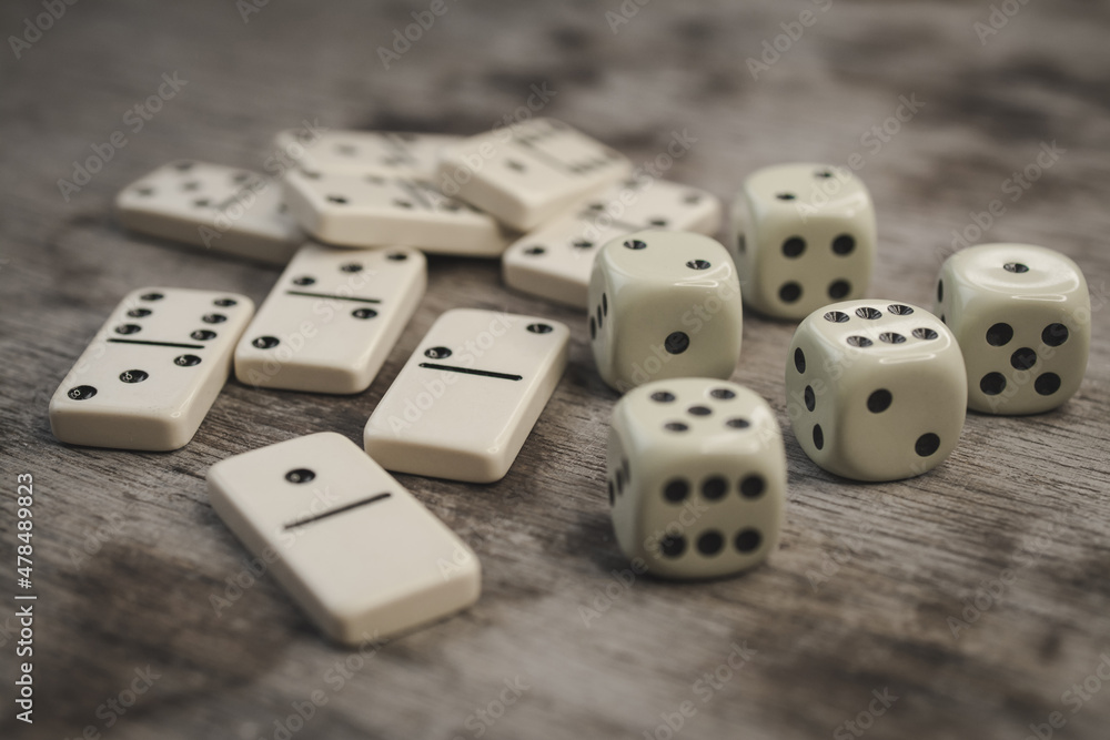 Dice and dominoes on wooden table, casino luck Dice and dominoes on wooden table, casino luck