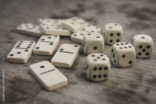 Dice and dominoes on wooden table  casino luck