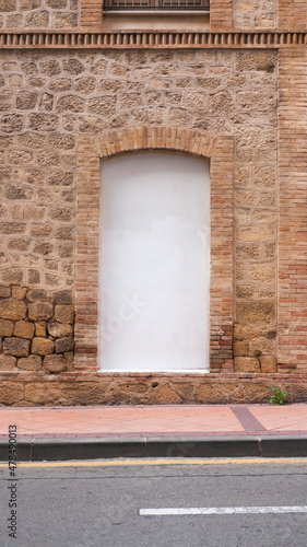 Ventana tapiada en fachada de piedra photo