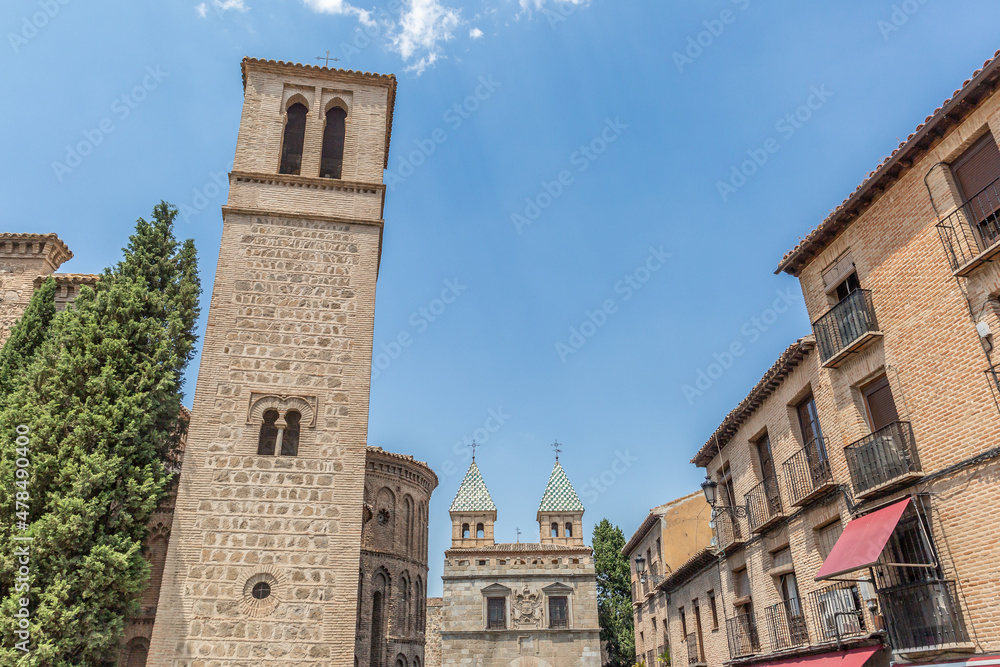 Picturesque view of a tower in the walled area and some typical houses of Toledo