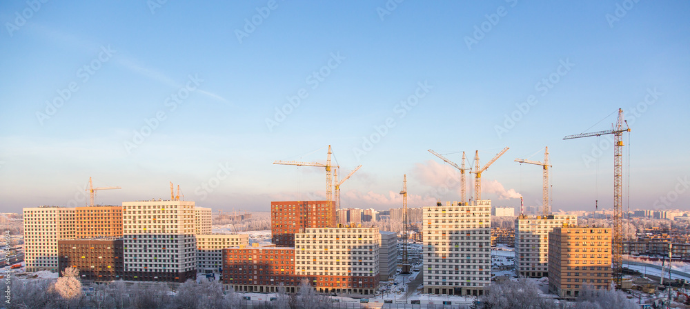panorama of active mass residential development in Moscow in winter on a sunny cold day