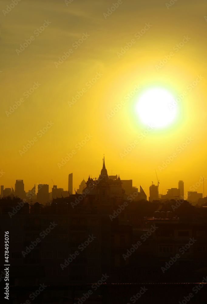 Fantastic Bright Sun Rising Over Bangkok City Skyline with the Silhouette of Phu Khao Thong (Golden Mount) Chedi of Wat Saket Temple, Thailand