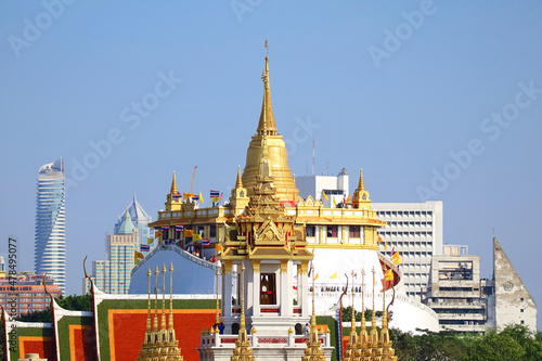 Stunning View of Phu Khao Thong (Golden Mount) of Wat Saket Temple with the Spires of Loha Prasat (Iron Castle) of Wat Ratchanatdaram Temple in Foreground, Bangkok City Skyline, Thailand