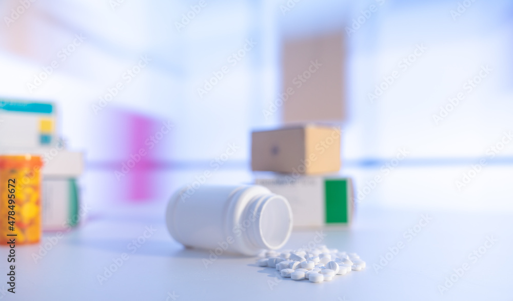 Pills an pill bottle on blurred background