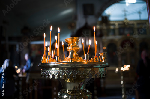 Burning candles against blur background of churcha photo