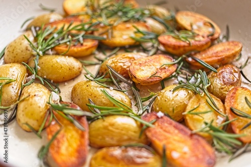 cooking fried potatoes in white pan