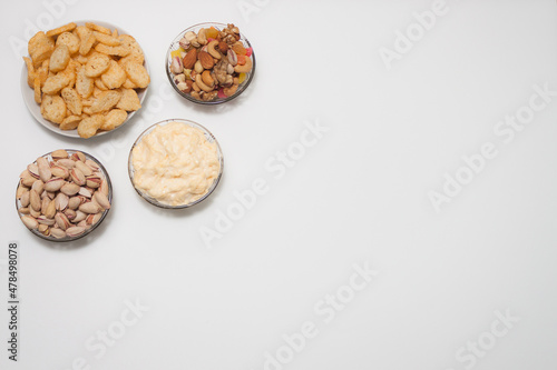 Nuts and snacks, a snack for beer on a white solid background.