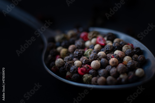 Various colored pepercorns on a dark background