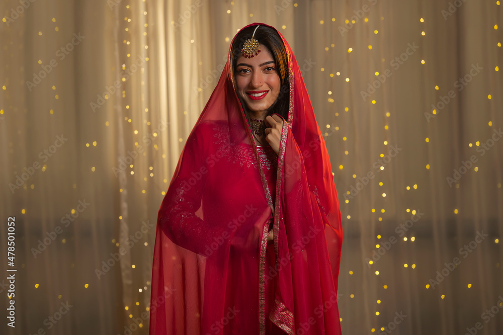 Young girl posing in front of camera with dupatta on occasion Young girl posing in front of camera with dupatta on occasion