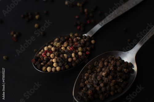 Various colored pepercorns on a dark background