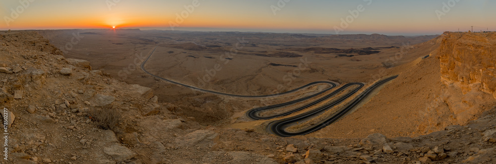 Sunrise panorama of winding road and Makhtesh Ramon, Negev Desert