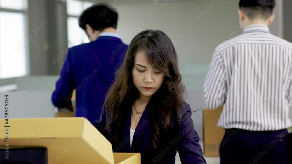 group of Asian employees are packing their stuff because they're fired. ,unemployed, fired from work, laid off. group of Asian employees are packing their stuff because they're fired. ,unemployed, fired from work, laid off.