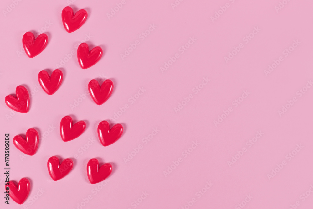 Valentine hearts on side of pink background with copy space