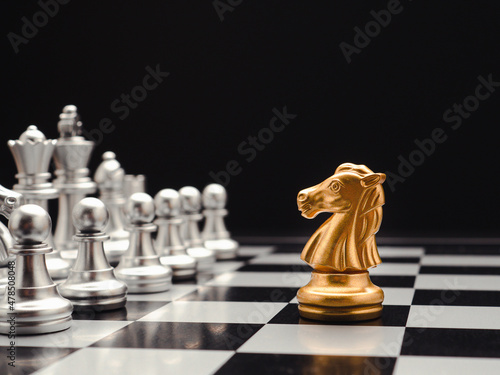 Chess pieces on board game planning and competition on black background
