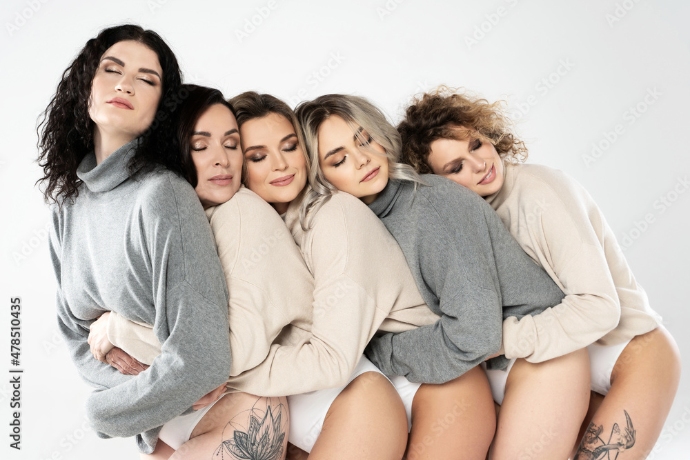 Group of different women wearing turtleneck jumpers on gray background Group of different women wearing turtleneck jumpers on gray background