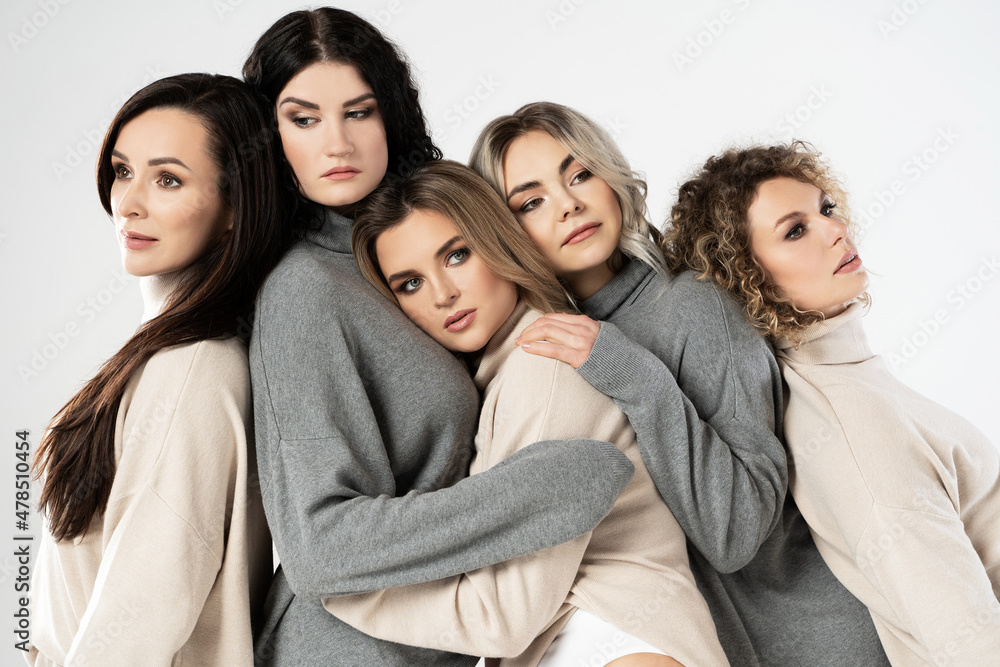 Group of different women wearing turtleneck jumpers on gray background