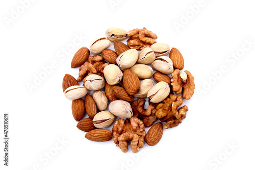 Various mix of nuts - almonds, pistachio, walnuts into the shape of a circle lisolated on a white background. Top view.