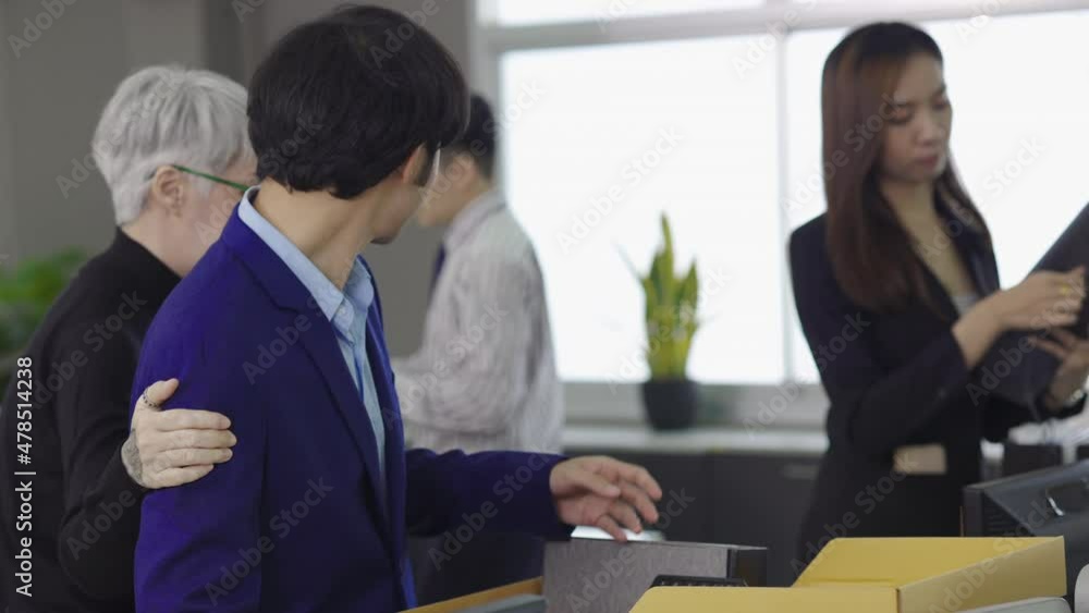 group of Asian employees are packing their stuff because they're fired. ,unemployed, fired from work, laid off. group of Asian employees are packing their stuff because they're fired. ,unemployed, fired from work, laid off.