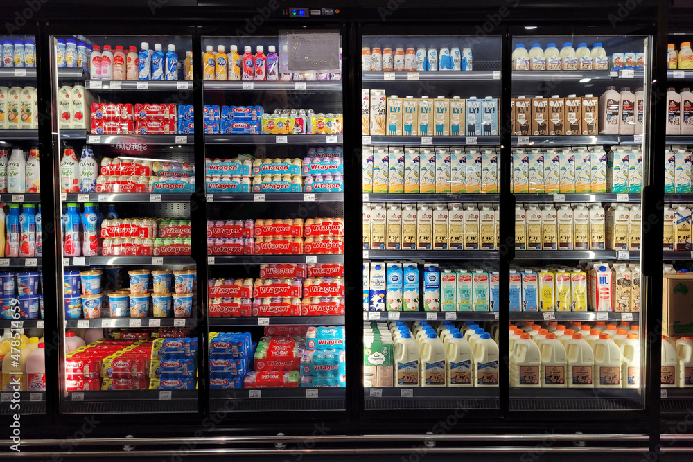 Various brands of fresh milk and yogurt drink on the refrigerator shelf ...
