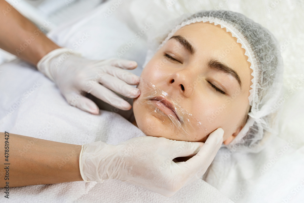 Professional permanent makeup artist applying anesthetic cream