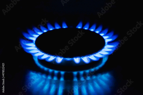 Flame of a gas burner on a black background. Combustion of Natural gas on a black background. Gas stove. Gas stove burner on fire. Fossil fuel. Hydrocarbons. Gas crisis in Europe. © Trik