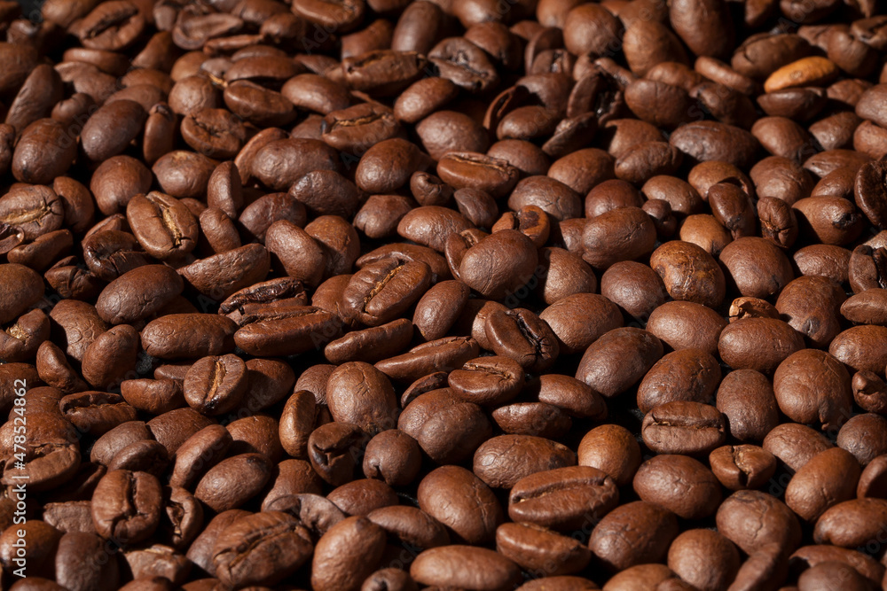 Beautiful background with coffee beans in dark colors Beautiful background with coffee beans in dark colors