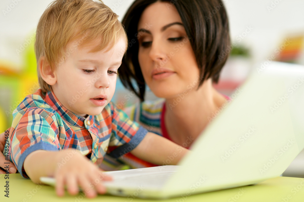 Close up portrait of mother and son using laptop together Close up portrait of mother and son using laptop together