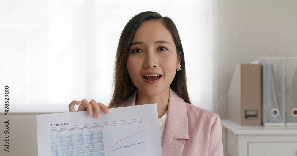 Trader loan agent show sale tax report talk, smile and look at video camera remote work on laptop at office. MBA asia college woman coach give advice to teach share plan in online learn media screen. Trader loan agent show sale tax report talk, smile and look at video camera remote work on laptop at office. MBA asia college woman coach give advice to teach share plan in online learn media screen.