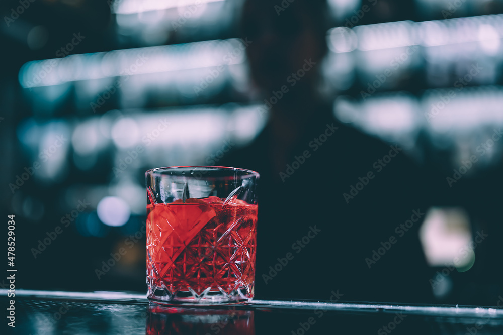 Cocktail Negroni with gin, campari martini rosso and orange. negroni  cocktail at the bar Photos | Adobe Stock