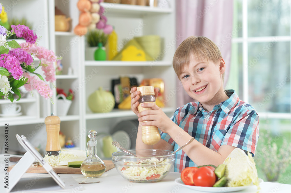 Portrait of cute little boy making dinner Portrait of cute little boy making dinner