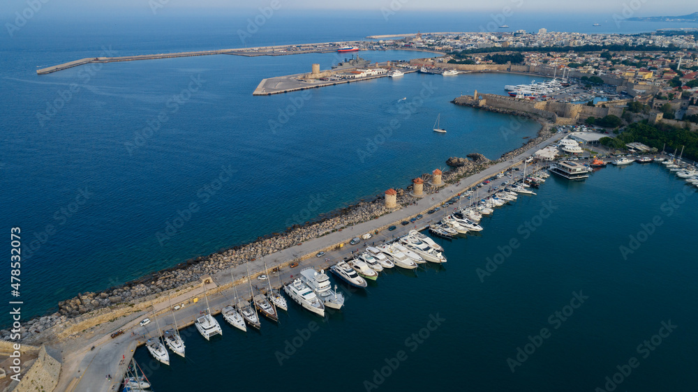 Mandraki port of Rhodes city harbor aerial panoramic view in Rhodes island in Greece. Sunset.