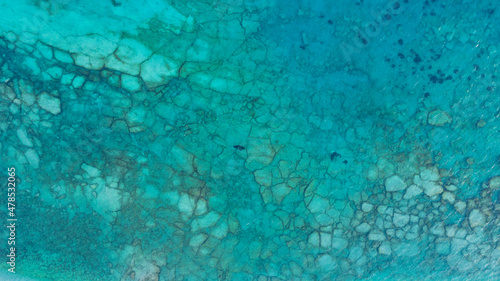 Aerial view of the rocky bottom of the Adriatic Sea covered with turquoise water. Deep sea and corals. Aquamarine background