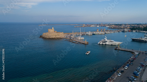Mandraki port of Rhodes city harbor aerial panoramic view in Rhodes island in Greece. Sunset.
