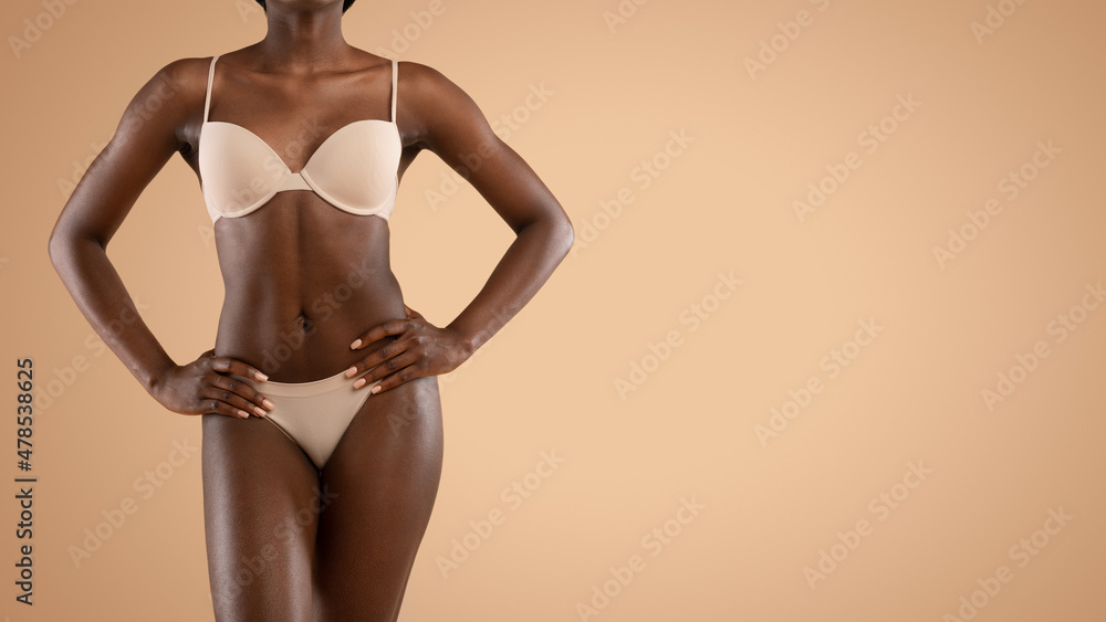 Pretty black woman standing in a black bodysuit. Stock Photo by  ©natalliajolliet 76034909