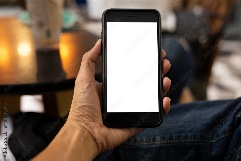 man hand using smartphone In the coffee shop,Screen blank with clipping path man hand using smartphone In the coffee shop,Screen blank with clipping path