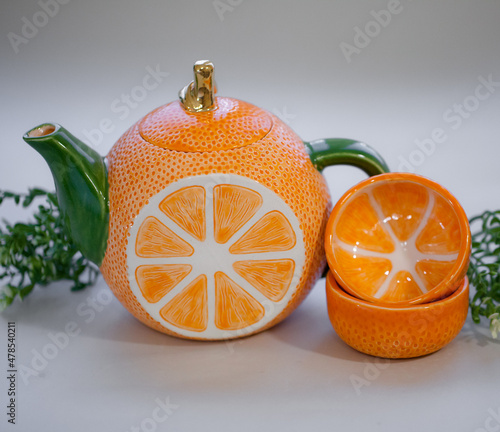 Ceramic teapot handmade orange with a gold leaf