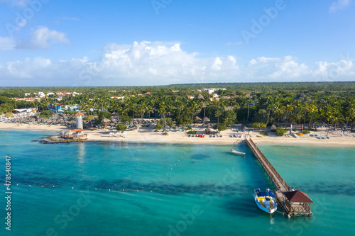 Obraz na plátně Dominicus beach at Bayahibe with Caribbean sea sandy seashore, lighthouse and pier