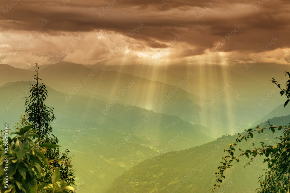 Sun rays coming out of cloud burst - at Rabangla, Sikkim, India. Trees ...