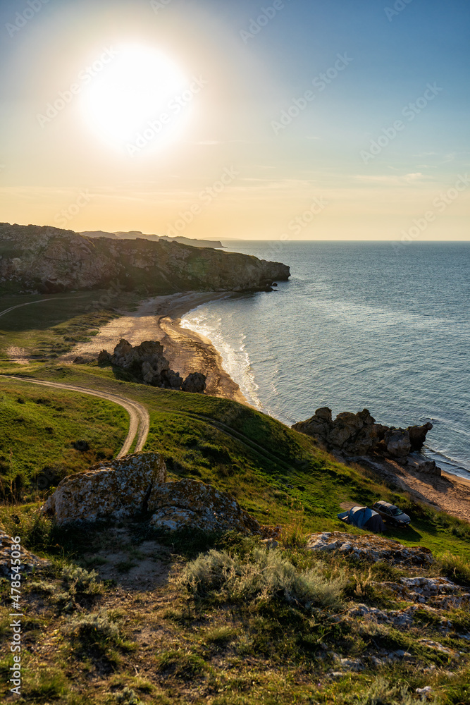Amazing landscape with sea bay, sand beach and coastal hills and rocks on summer evening at sunset. Trip to seaside. General's beaches or Generalskie Plyazhi or coast of thousand bays, Crimea